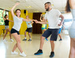 © JackF - Tree smiling couples dancing rock-and-roll in dancing-class