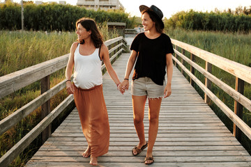 Wall Mural - Mesmerizing shot of a lovely pregnant couple - lesbian family concept