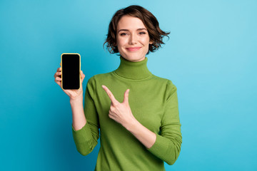 Canvas Print - Portrait of positive girl promoter point index finger smartphone advise decide choose technology feedback wear good look sweater isolated blue color background