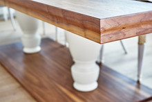 Wooden Dinner Table On Massive Legs In Modern Apartment. Close-up