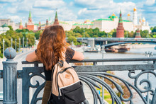 Portrait Of A Beautiful Young Female Tourist With A View Of The Kremlin In Moscow, Russia