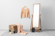 © Pixel-Shot - Stylish interior of dressing room with pouf, clothes and mirror