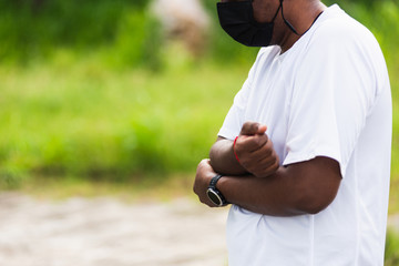 Close up Asian young sport runner black man wear watch he having elbow pain and use hands joint hold elbow while exercising at the outdoor street health park, healthy exercise Injury from workout