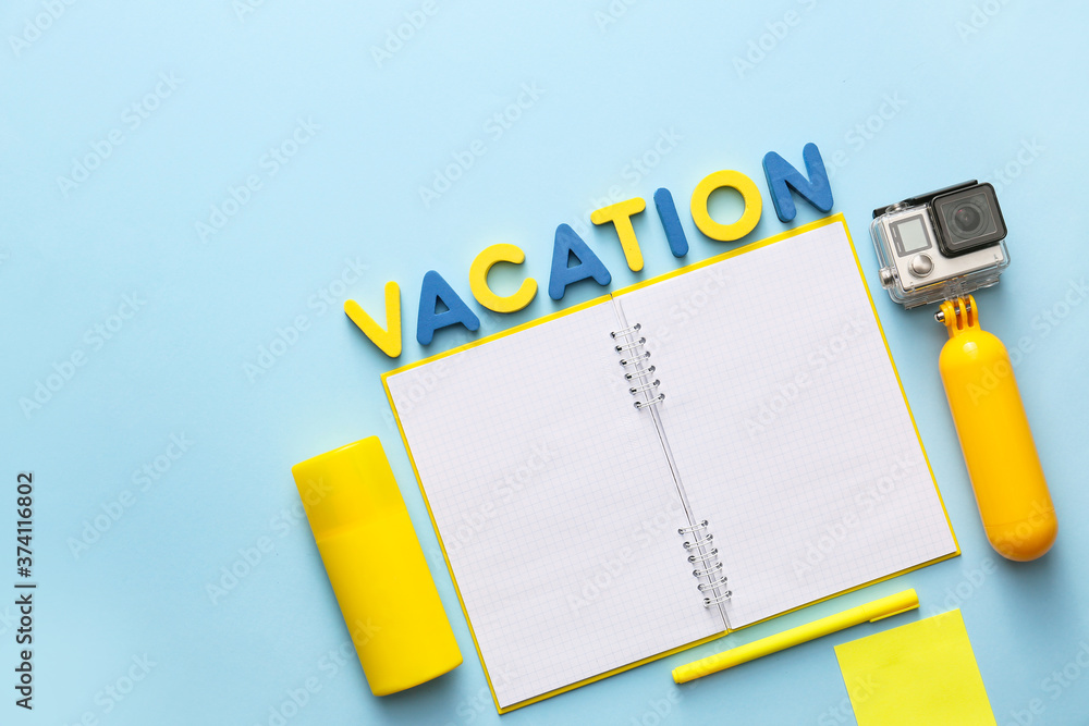 Composition with notebook and word VACATION on color background