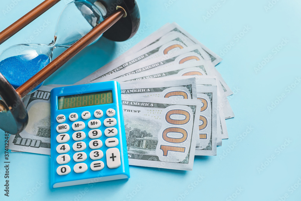 Hourglass with calculator and money on color background