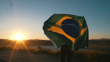 Brazilian Girl With National Flag At Sunrise