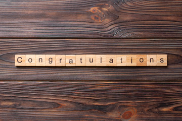 congratulations word written on wood block. congratulations text on wooden table for your desing, concept