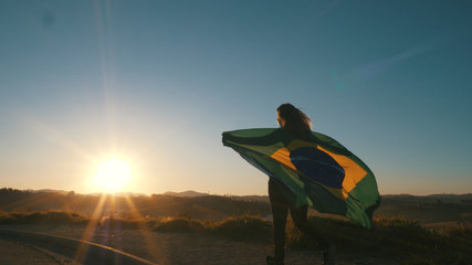 Brazilian Girl with National Flag at sunrise