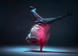 Cool young guy breakdancer dancing hip-hop in neon light. Dance school poster. Long exposure shot