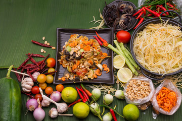 Wall Mural - Thai papaya salad is street food It is a favorite food for both Thais and foreigners With seasoning roasted nuts lime papaya chili pickled crab fermented fish garlic dried shrimp top view.