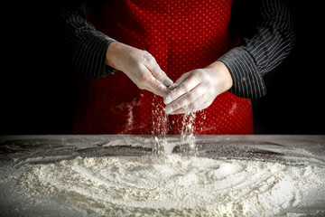 Flour hands and a wooden table with a free space for an advertising product