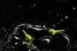 Eggplant on a black background with drops and splashes of water