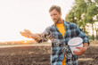 © LIGHTFIELD STUDIOS - selective focus of farmer in plaid shirt sowing seeds on plowed field