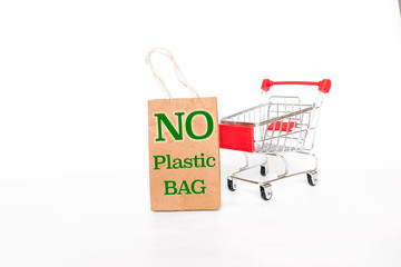 No plastic bag sign on paper shopping bag with empty shopping cart on white background, business object