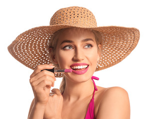 Wall Mural - Beautiful young woman with lipstick on white background