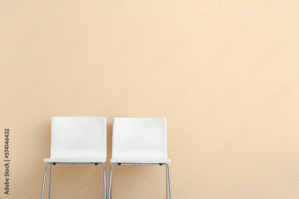 Modern chairs near color wall