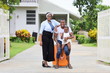 © Akarawut - African American family is moving in to a new house with father holding baby with suitcase and baggage with happy smile