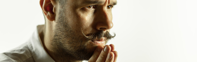 Wall Mural - Praying. Caucasian young man's close up cropped shot on studio background, flyer. Concept of human emotions, facial expression, sales, ad. Copyspace. Beautiful male model with bright expression.