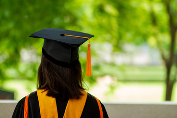 Wall Mural - A black hat with a yellow tassel from a university graduate.