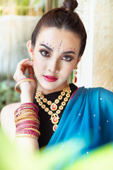 Portrait of young asian girl with kundan jewelry set and traditional hindu Indian costume saree and lehenga dress model