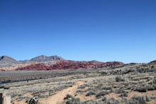 Red Rock Layers With Rock Mountain In Desert