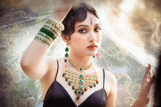 Portrait of young asian girl with kundan jewelry set and traditional hindu Indian costume saree and lehenga dress model