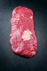 Wall Mural - Raw wagyu bavette aloyau beef steak offered as top view on rustic black board with copy space