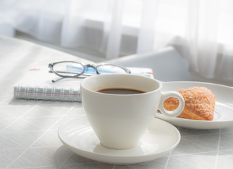 Close up a cup of black coffee white porcelain on the table with apple puff, coffee break concept