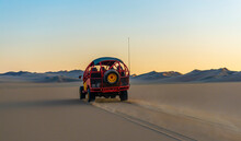 Desert Buggy Driving Through The Nazca Desert At Sunset Between Ica And Huacachina, Peru.