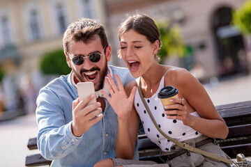 Wall Mural - Couple take selfie in the city.