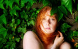 © ullision - Sensual sexy portrait of beautiful red-haired woman outdoors with ivy background , copy space