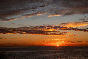 Wall Mural - Sunrise and clouds by the coastline