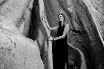 Portrait of a girl with a painted face and an ancient tree.
Woman and nature.