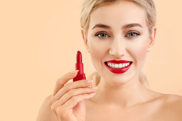 Poster - Beautiful young woman with lipstick on color background