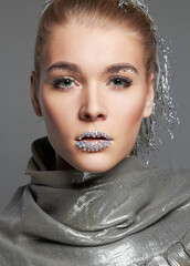 fashion portrait of beautiful woman with crystals on lips