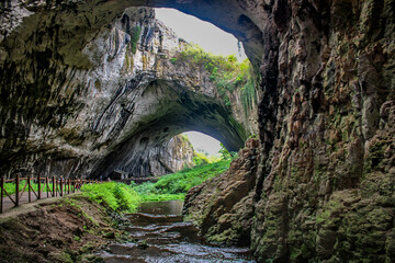 Poster - Devetashka cave,is a large karst cave around 7 km (4.3 mi) east of Letnitsa and 15 km (9.3 mi) northeast of Lovech Bulgaria.Devetashka cave was shown in the action movie The Expendables 2