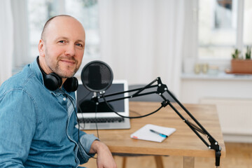 Middle-aged man recording a podcast