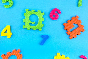 Soft block numbers children toys on blue background. Education concept. Creative concept. Flat lay, copy space, top view.