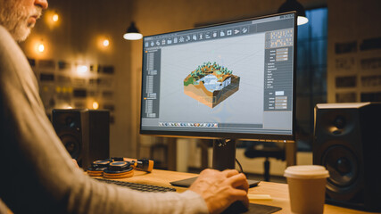 Wall Mural - in the evening creative middle aged video game developer works on a desktop computer with screen 3d 