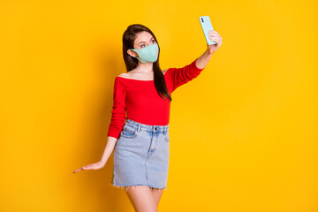 Sticker - Photo of joy girl in medical mask use smartphone make selfie covid quarantine wear red top short mini skirt isolated over bright shine color background