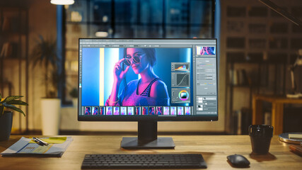 Wall Mural - shot of a desktop computer in the modern office with monitor showing photo editing software. in the 