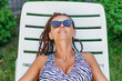Tan. Woman in swimsuit sunbathing in the sun.