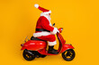 Profile side view of his he nice funny fat thick white-haired Santa riding motor bike fast speed hurry up rush shopping sale hat ball fly isolated bright vivid shine vibrant yellow color background