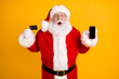 © deagreez - Portrait of his he nice cheerful funny amazed glad white-haired Santa holding in hands using bank card device app shop web service buy isolated bright vivid shine vibrant yellow color background