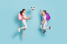 Full Length Body Size View Of Two Attractive Small Little Cheerful Friends Friendship Jumping Play Soccer Cup Goal Throwing Ball Hobby Leisure Isolated Blue Pastel Color Background