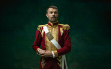 Highly Serious. Young Man In Suit As Nicholas II Isolated On Dark Green Background. Retro Style, Comparison Of Eras Concept. Beautiful Male Model Like Historical Character, Monarch, Old-fashioned.