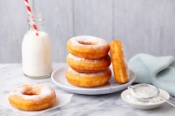 Wall Mural - Donuts with bottle of milk on marble table. Grey background. Close up.