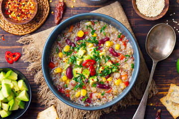 Vegetable quinoa soup, stew with avocado, corn, beans. South American traditional dish. Close up. Top view.