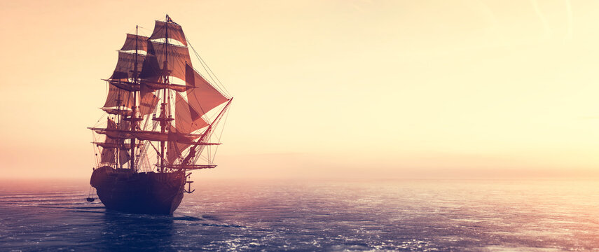 pirate ship sailing on the ocean at sunset