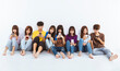© Tom Wang - young group using smartphones and  sitting on the floor